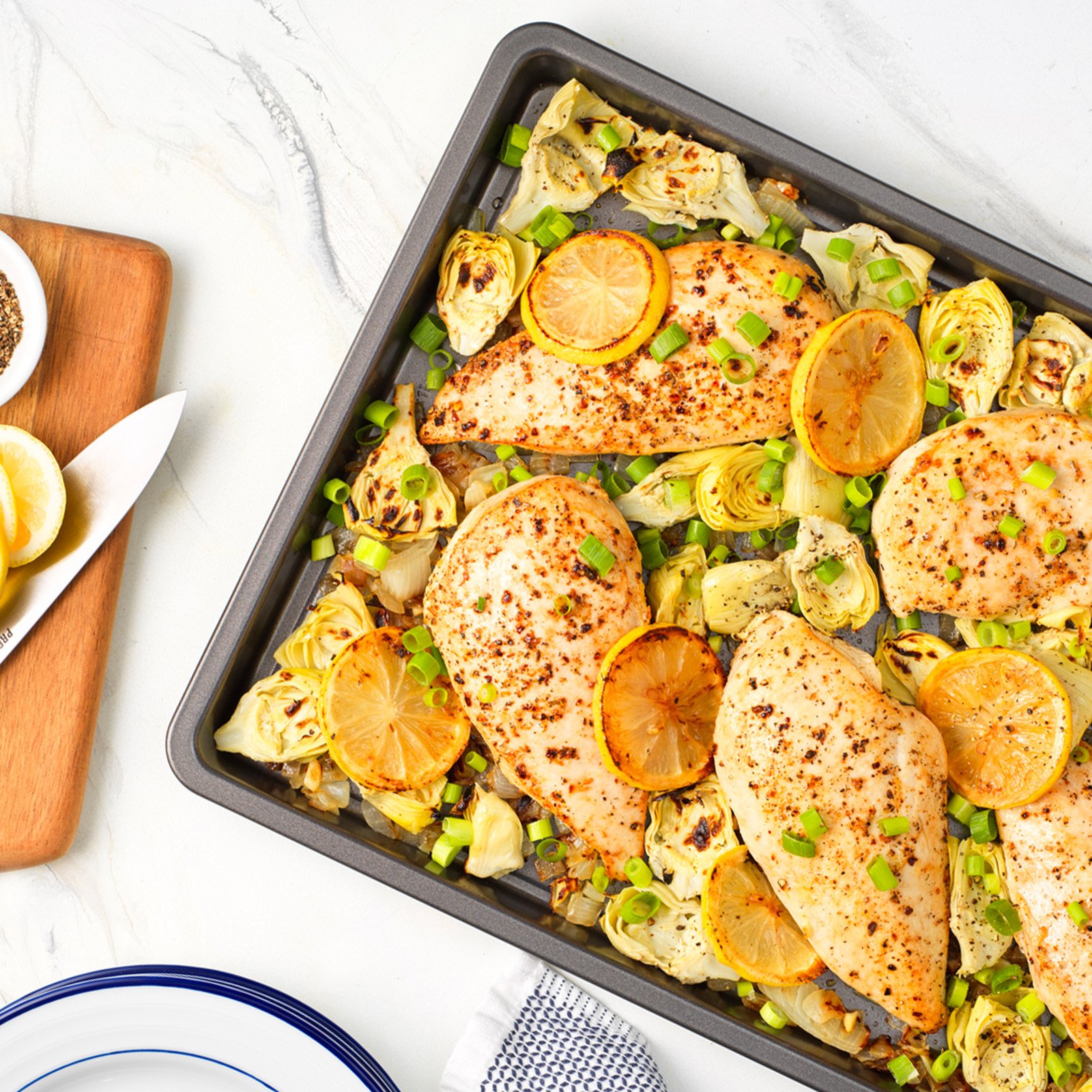 Easy sheet pan lemon chicken with artichokes and green onions — healthy baked chicken dinner recipe.